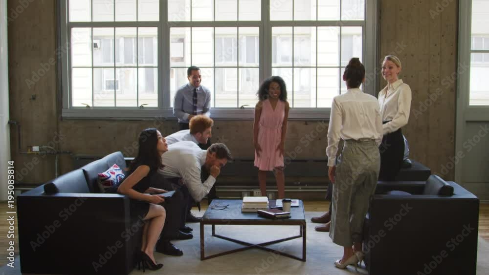 Female boss and colleagues celebrating at a casual meeting Female boss and colleagues celebrating at a casual meeting