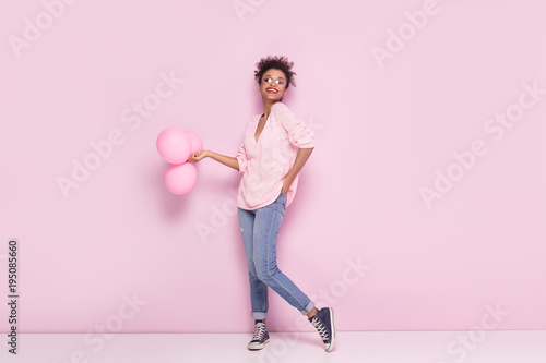 Happy afro girl with amazing smile posing on pink background.