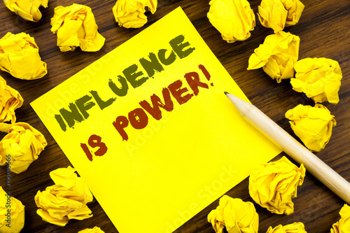 Word, writing Influence Is Power. Business concept for Persuasion Strategy Written on sticky note paper, wooden background with folded yellow paper meaning thinking