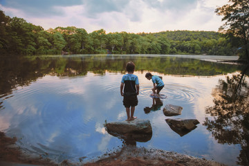 children caught fish in the lake. boys playing near the water