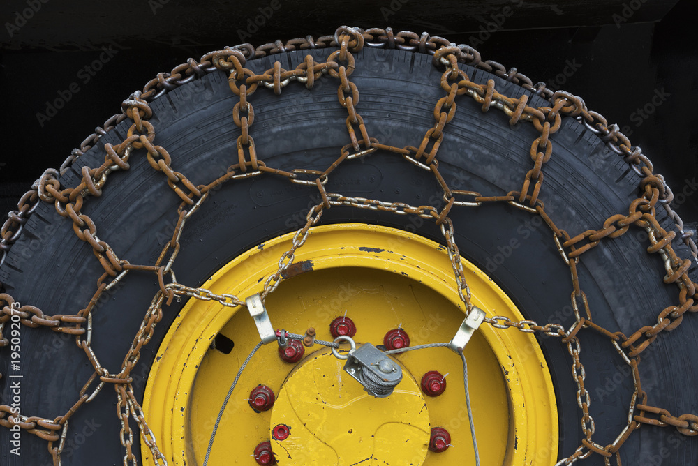 Naklejka premium rusty snow chains on tire