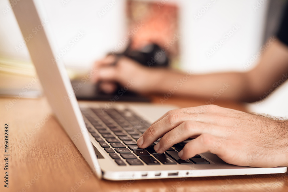 Close up freelancer bearded man drawing at laptop sitting at desk. Close up freelancer bearded man drawing at laptop sitting at desk.