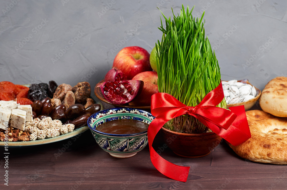 Traditional Azerbaijan holiday Nowruz: national dessert called Sumalak and Fresh green grass samani symbol of spring