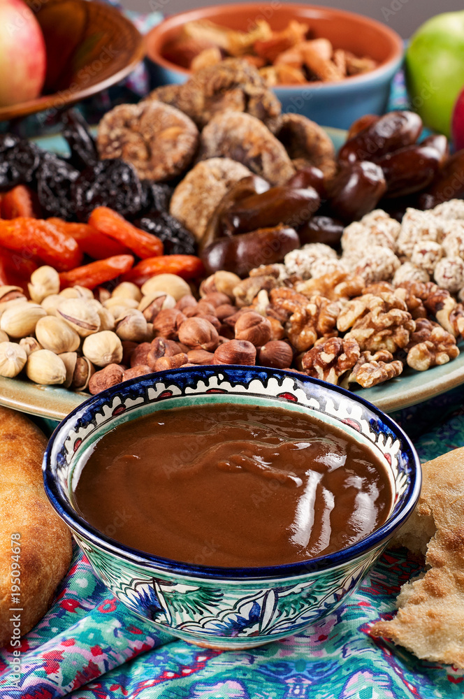 Traditional Azerbaijan sweet cuisine of holiday Nowruz: national dessert Sumalak, assortment of nuts and dry fruits