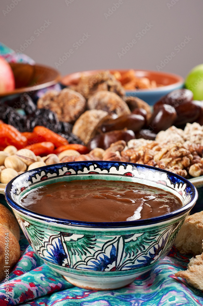 Traditional Azerbaijan sweet cuisine of holiday Nowruz: national dessert Sumalak, assortment of nuts and dry fruits
