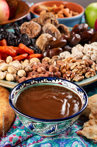 Obraz na płótnie Traditional Azerbaijan sweet cuisine of holiday Nowruz: national dessert Sumalak, assortment of nuts and dry fruits w salonie
