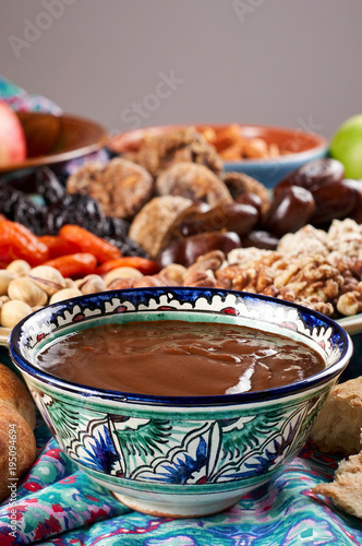 Obraz na płótnie Traditional Azerbaijan sweet cuisine of holiday Nowruz: national dessert Sumalak, assortment of nuts and dry fruits w salonie