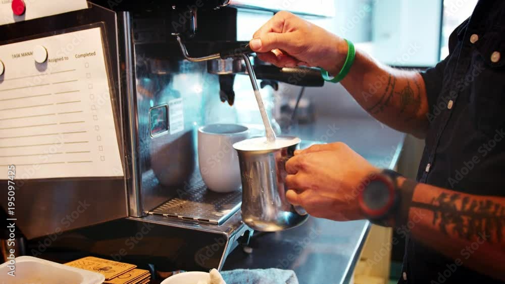 Close Up Of Barista Frothing Hot Milk To Add To Coffee Close Up Of Barista Frothing Hot Milk To Add To Coffee