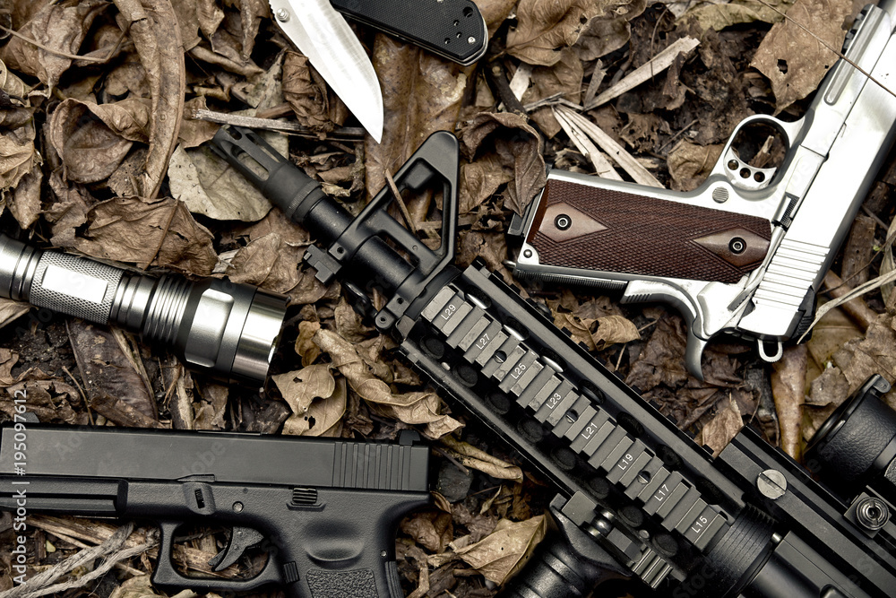 Weapons and military equipment for army, Assault rifle gun and pistol on camouflage background.