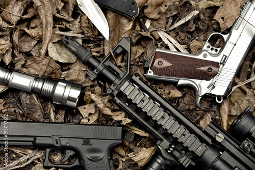 Obraz na płótnie Weapons and military equipment for army, Assault rifle gun and pistol on camouflage background. w salonie