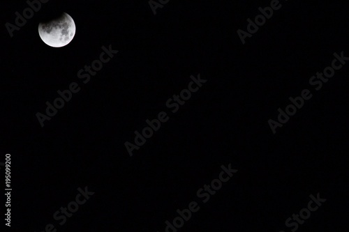 Partial Eclipse of moon, located top left corner of photo