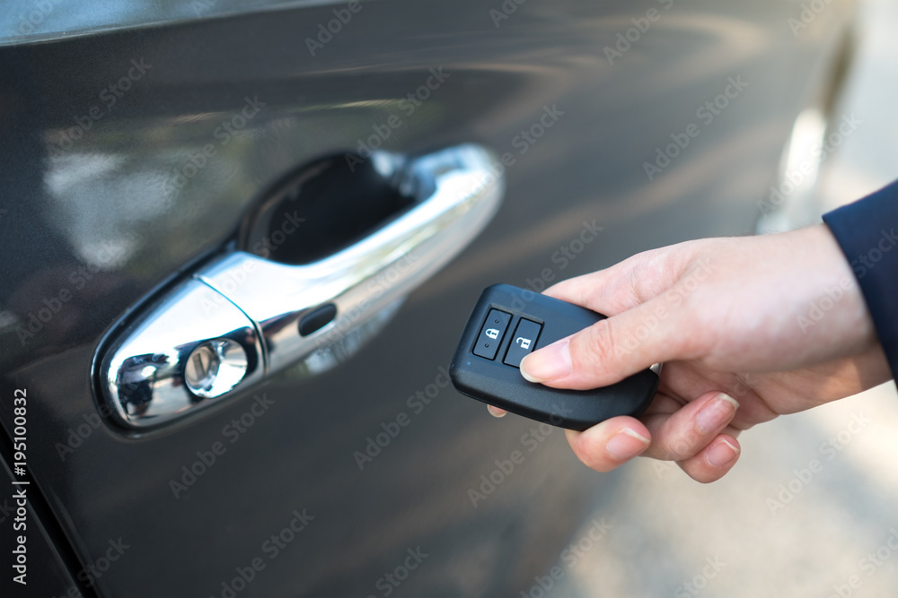 Close-up of female in formal wear opening a car door by remote