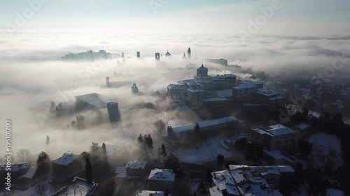 Bergamo, Italy. Drone aerial view of an amazing landscape of the fog rises from the plains and covers the old town