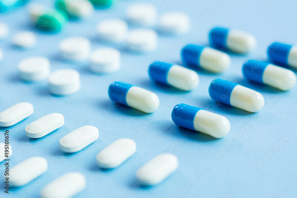 Medical tablets on light blue background Medical tablets on light blue background