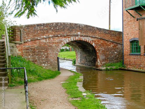 Old bridge with towpath on the Shropshire Union canal in Market Drayton, England photo