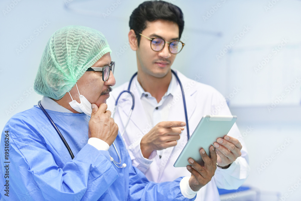 Asian surgeon team using digital tablet at work in operating room Asian surgeon team using digital tablet at work in operating room