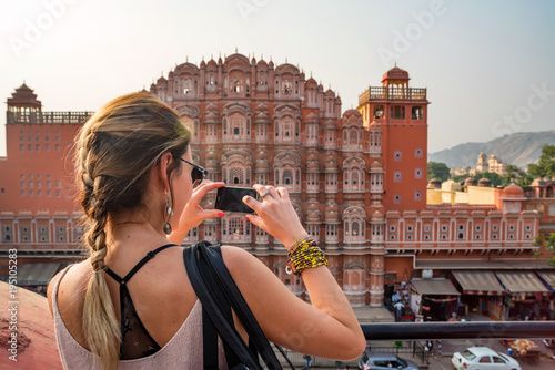 Photography Young woman takes picture of Hawa Mahal in India