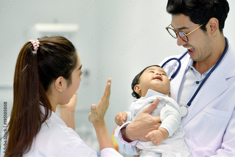 Asian paediatrician is taking care of baby in hospital Asian paediatrician is taking care of baby in hospital