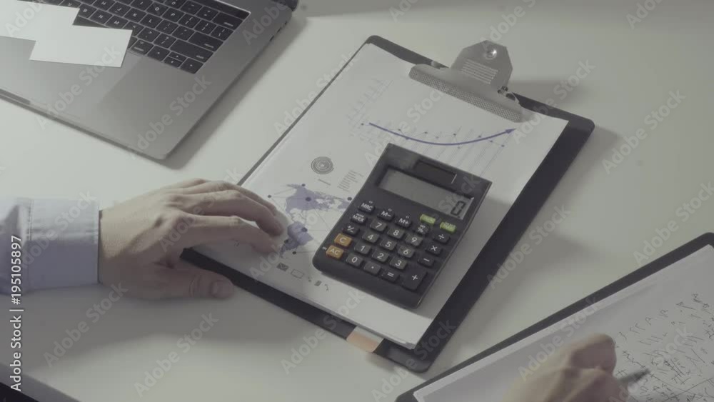 businessman hand working with finances about cost and calculator and laptop with mobile phone on withe desk in modern office
businessman hand working with finances about cost and calculator and laptop with mobile phone on withe desk in modern office