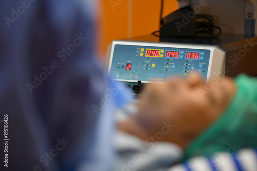 Surgeon inspecting a cardiogram when treating patient