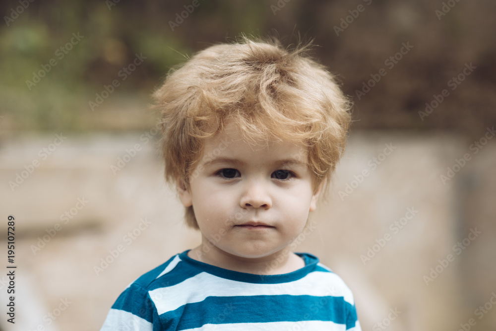 Child or boy with serious face wears striped clothes. Child or boy with serious face wears striped clothes.