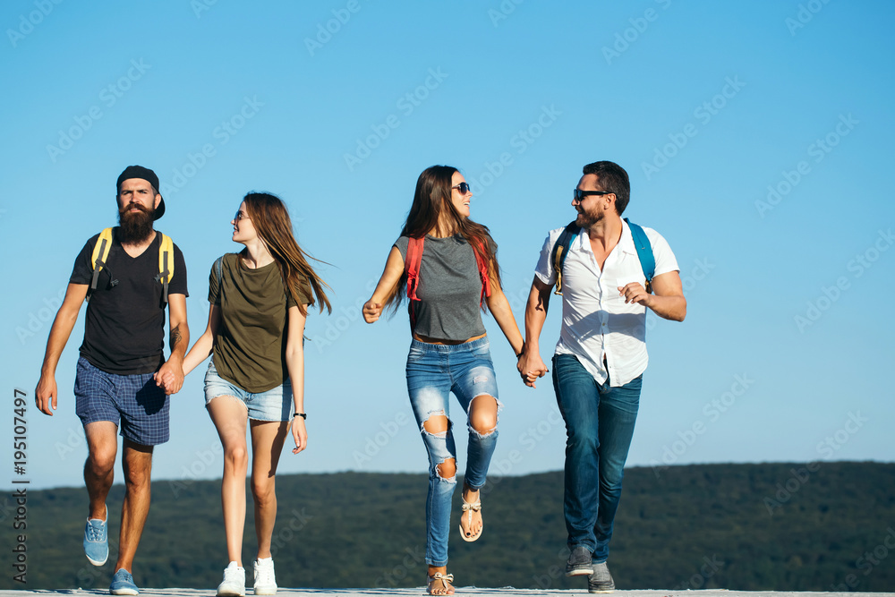 Fototapeta premium Four happy friends on mountains and having fun together