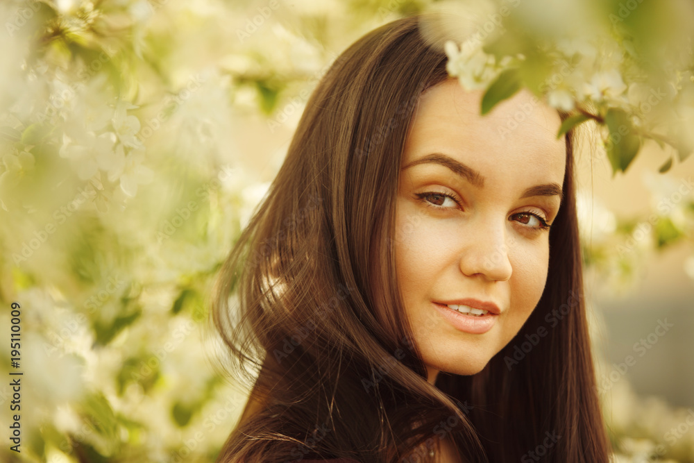 young woman with clean skin near a blooming apple tree. portrait of girl in spring park. young woman with clean skin near a blooming apple tree. portrait of girl in spring park.
