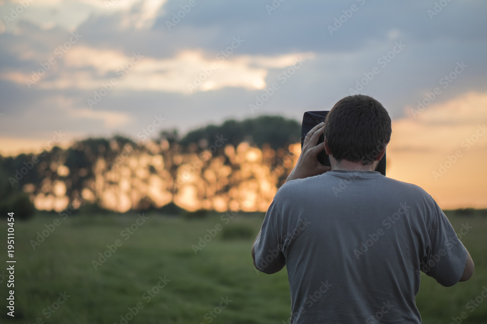 Photographer taking pictures of sundown Photographer taking pictures of sundown