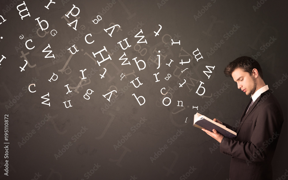 Young man holding book with letters Young man holding book with letters