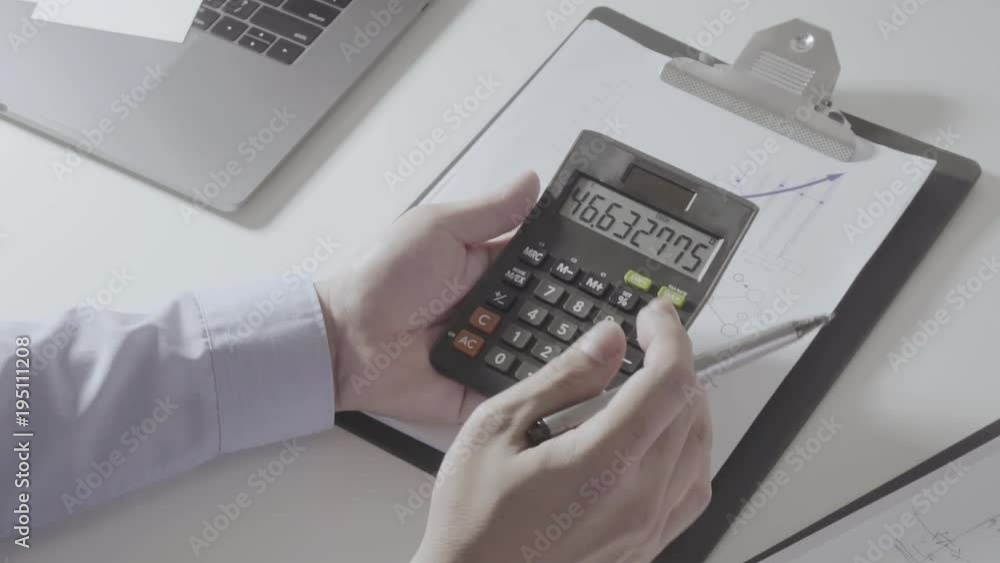 businessman hand working with finances about cost and calculator and laptop with mobile phone on withe desk in modern office
businessman hand working with finances about cost and calculator and laptop with mobile phone on withe desk in modern office