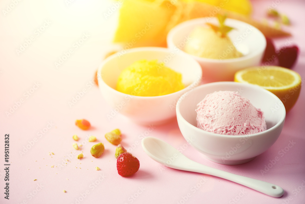 Red, pink, yellow, green, white ice cream balls in bowls, waffle cones, berries, orange, mango, lemon, mint, pistachio, pink shabby chic background. Ice-cream colorful collection, summer concept Red, pink, yellow, green, white ice cream balls in bowls, waffle cones, berries, orange, mango, lemon, mint, pistachio, pink shabby chic background. Ice-cream colorful collection, summer concept
