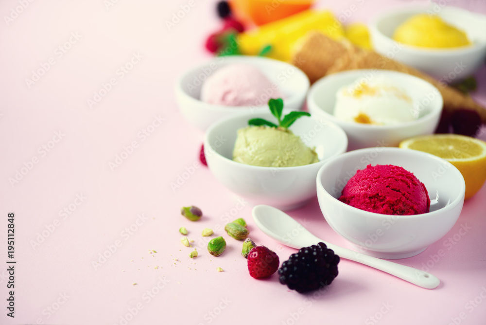 Red, pink, yellow, green, white ice cream balls in bowls, waffle cones, berries, orange, mango, lemon, mint, pistachio, pink shabby chic background. Ice-cream colorful collection, summer concept Red, pink, yellow, green, white ice cream balls in bowls, waffle cones, berries, orange, mango, lemon, mint, pistachio, pink shabby chic background. Ice-cream colorful collection, summer concept