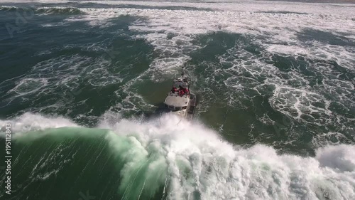 coast guard high to low over wave, rough seas, rouge wave crashing over boat agitated water, Drone aerial video, 4k, rescue, marine, pacific, tide, surge, danger, dangerous waves raw photo