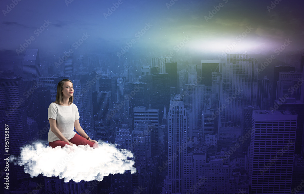 Naklejka premium Woman sitting on cloud above the city