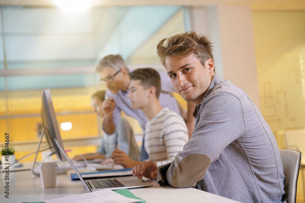 Fototapeta premium Teacher with students in apprenticeship attending computing class