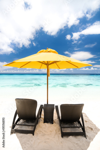 Sun umbrella and beach beds on beach © photopixel