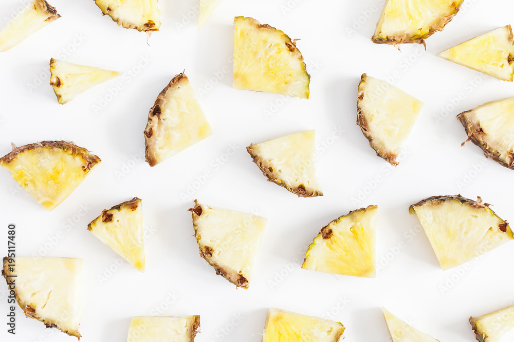 Pineapples on white background. Pattern made of sliced pineapples. Flat lay, top view Pineapples on white background. Pattern made of sliced pineapples. Flat lay, top view