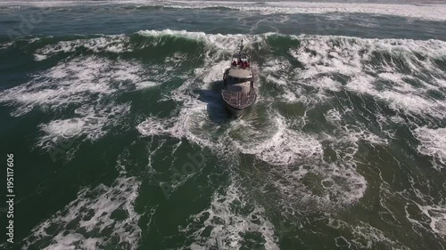 coast guard front over waves, rough seas, rouge wave crashing over boat agitated water, Drone aerial video, 4k, rescue, marine, pacific, tide, surge, danger, dangerous waves raw