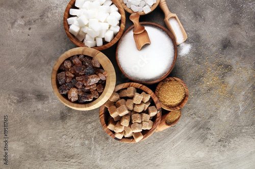 Various types of sugar, brown sugar and white on table