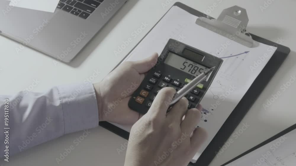 businessman hand working with finances about cost and calculator and laptop with mobile phone on withe desk in modern office
businessman hand working with finances about cost and calculator and laptop with mobile phone on withe desk in modern office
