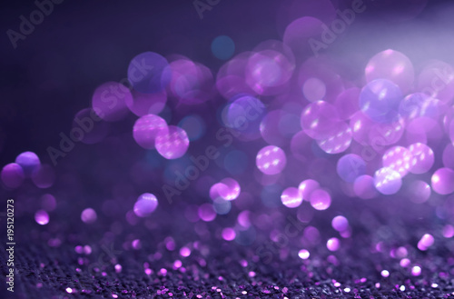 Sparkling Glitter abstract background dark purple saturated color ,de-focused, macro. Sequins fall and sparkle, round bokeh.