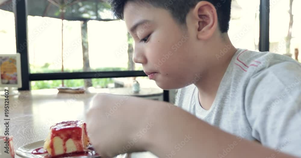 Happy asian child enjoy eating cake together Happy asian child enjoy eating cake together