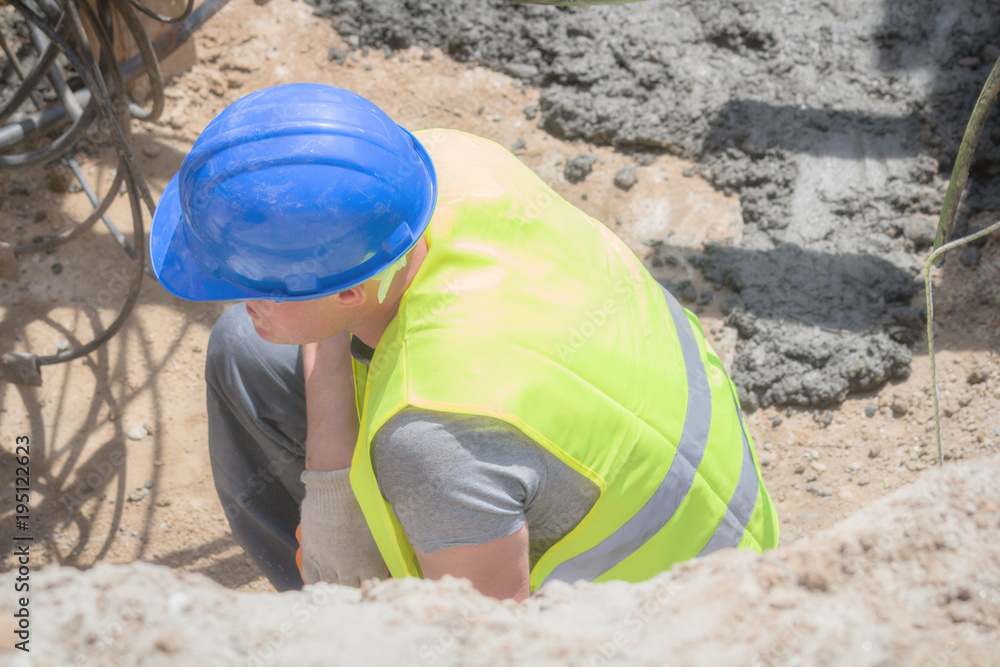 Worker with electrical power line cables underground. Worker with electrical power line cables underground.