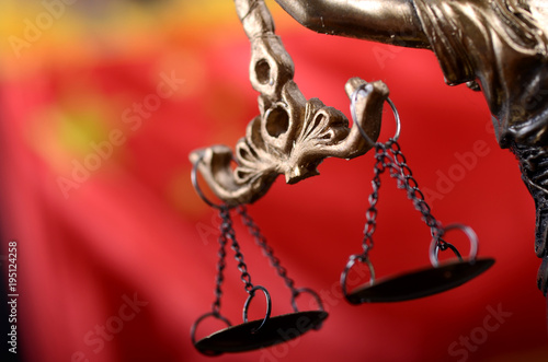 Scales of Justice, Justitia, Lady Justice in front of the flag of China in the background.