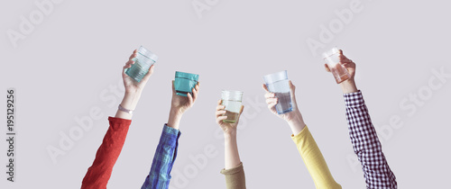 Different people holding water glass