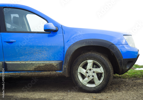 dirty blue car full of mud
