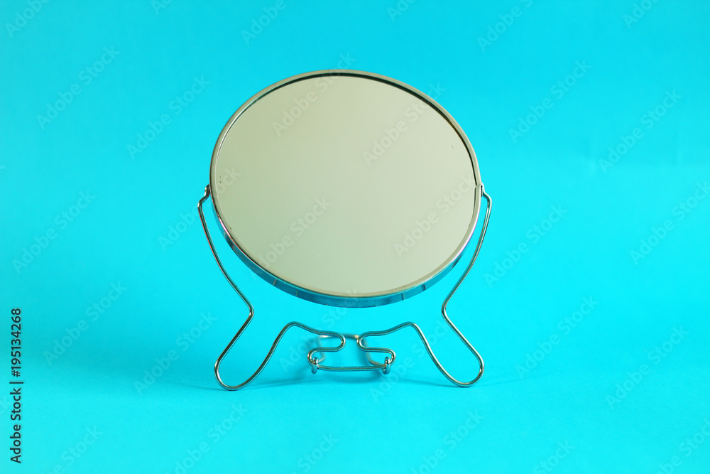Close up on the make up mirror, blue background Close up on the make up mirror, blue background