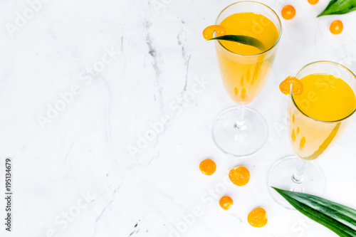 cocktail with physalis in glass on stone background