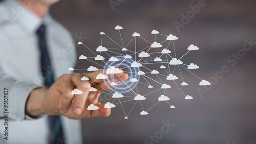 Man touching a cloud network on a touch screen
