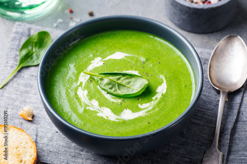 Spinach soup with cream in a bowl. Close up.